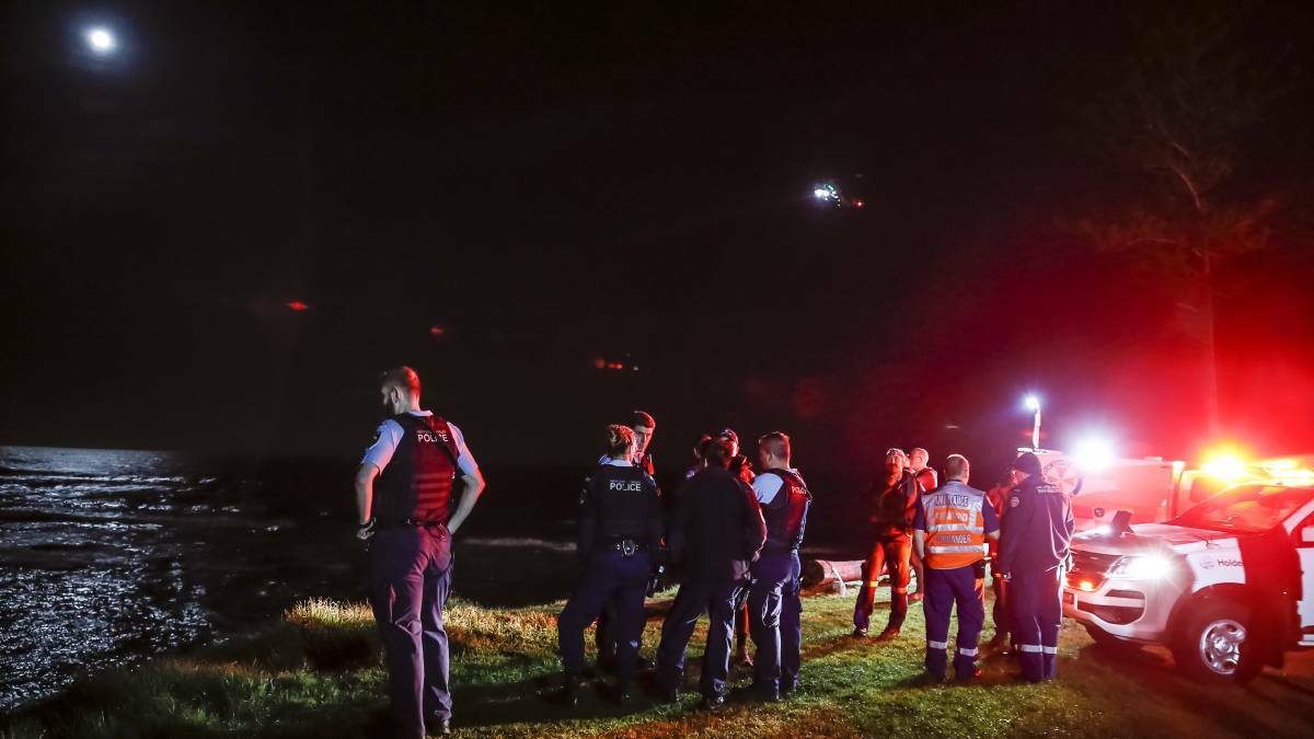 Emergency services at Bulli Point on the night a fishing boat overturned.