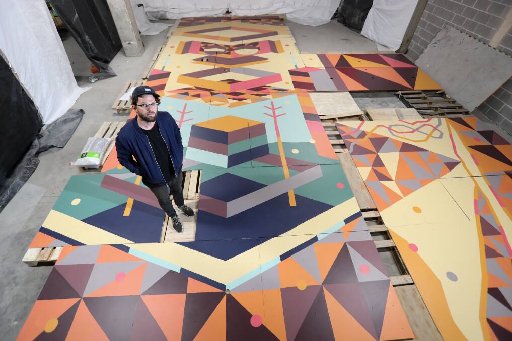 Internationally renowned Australian artist Kyle Hughes-Odgers working on a massive abstract creation. 