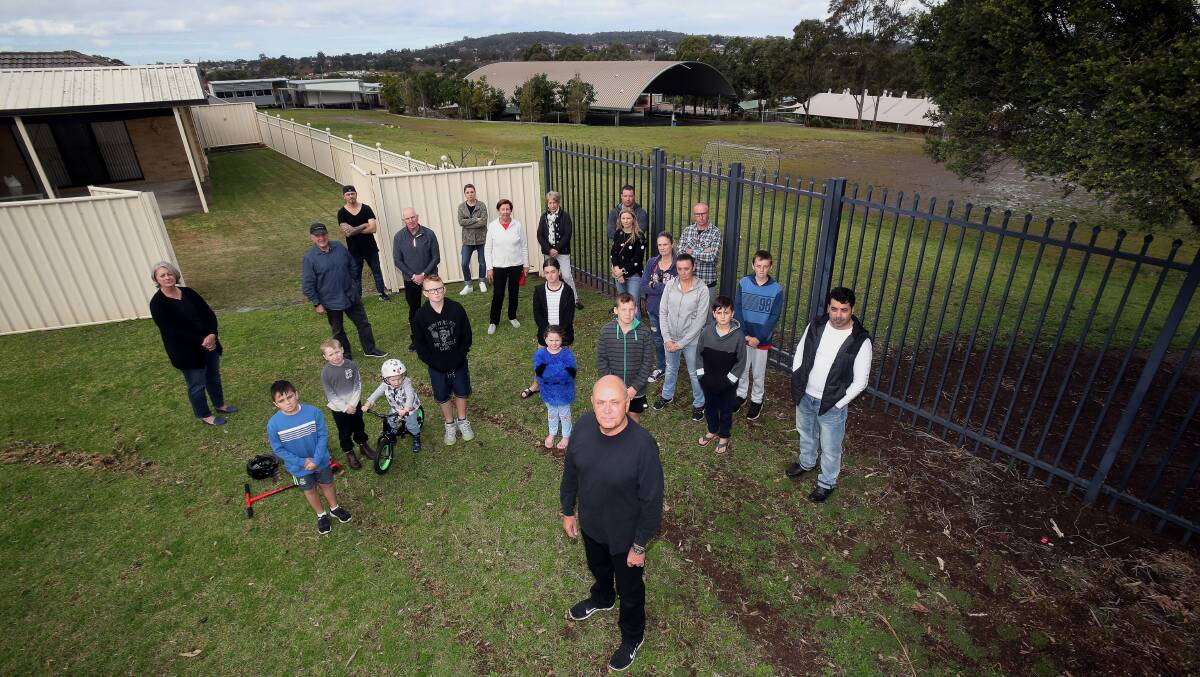 Glen Bradley (front), whose property backs onto the school's playground, with fellow residents. Picture: Robert Peet