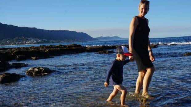 Sea change: Amber Joyce and her son Billy on the beach in Thirroul. 
