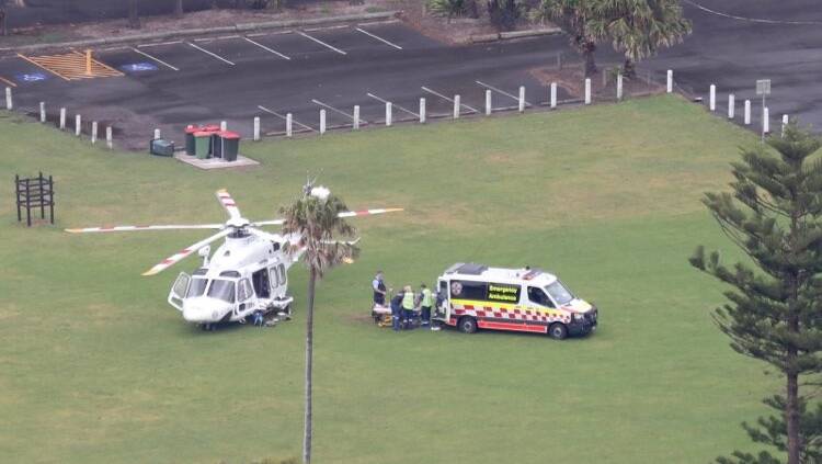 A patient is loaded into a rescue chopper at Stanwell Park. Photo: Adam McLean