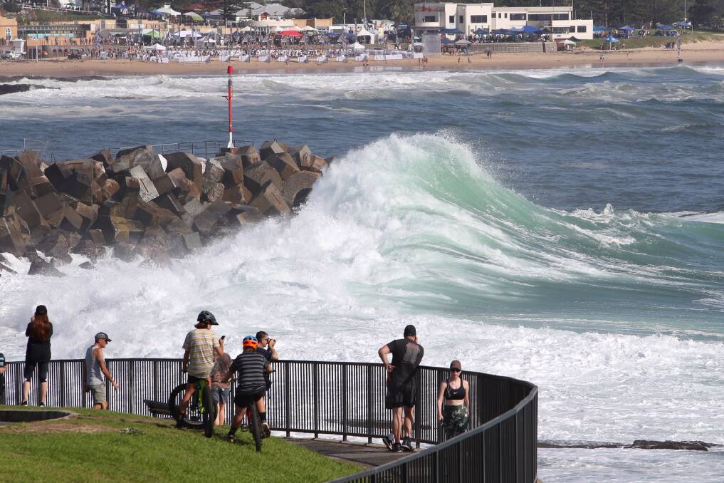 Despite the huge seas, fitness event Tribal Clash is underway at North Wollongong beach
