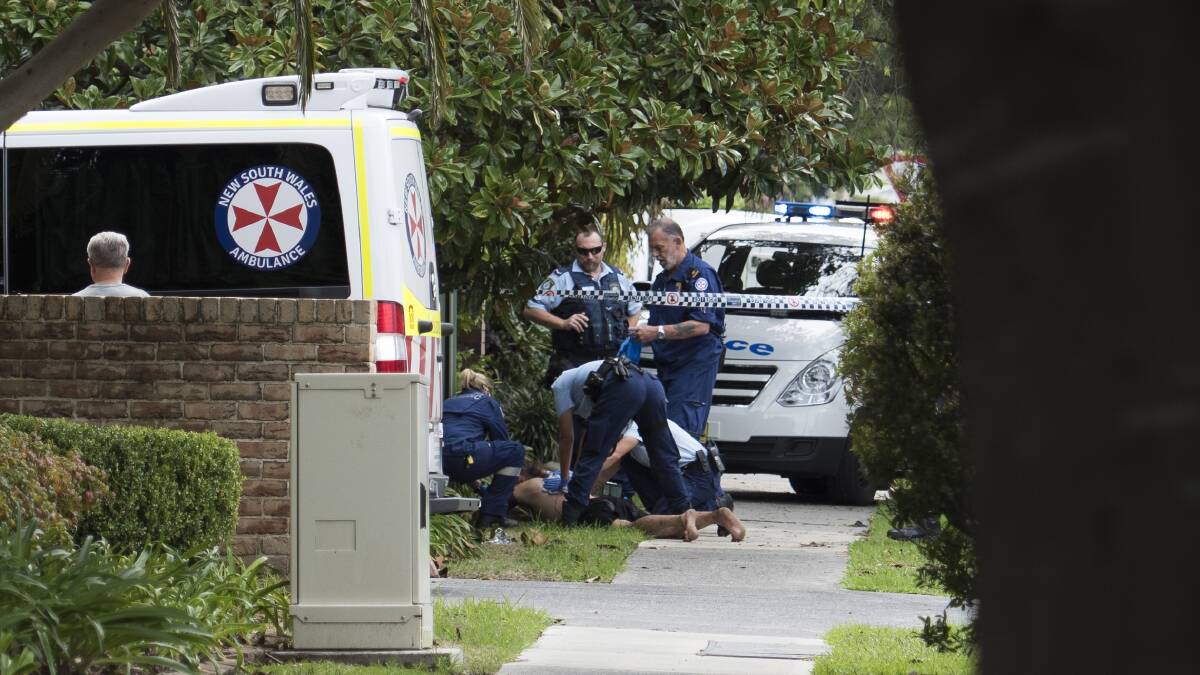 A man wounded in an alleged axe attack on Corrimal Street is tended to. Pictures: Matt Dobson - Media Australis