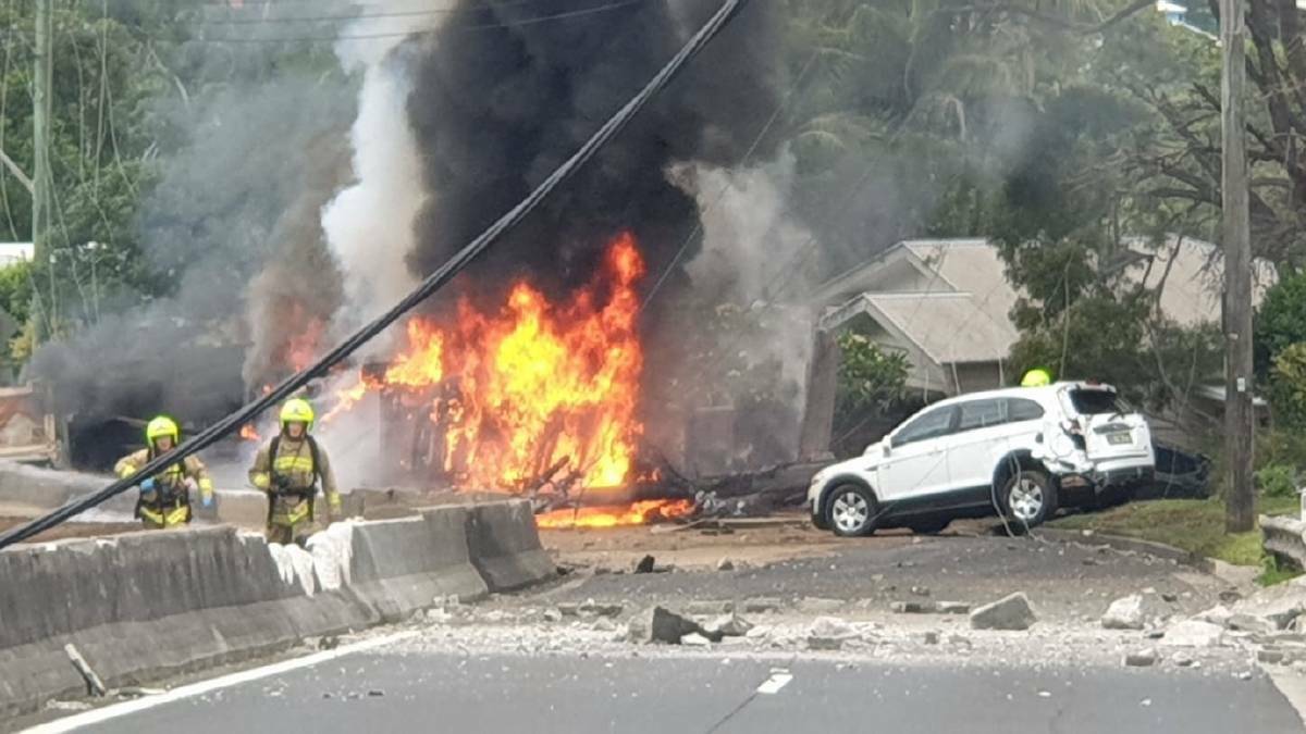 A truck travelling down Bulli Pass on Monday afternoon lost control, slammed into a concrete median barrier and flipped onto the opposite side of the road and exploded in flames 

