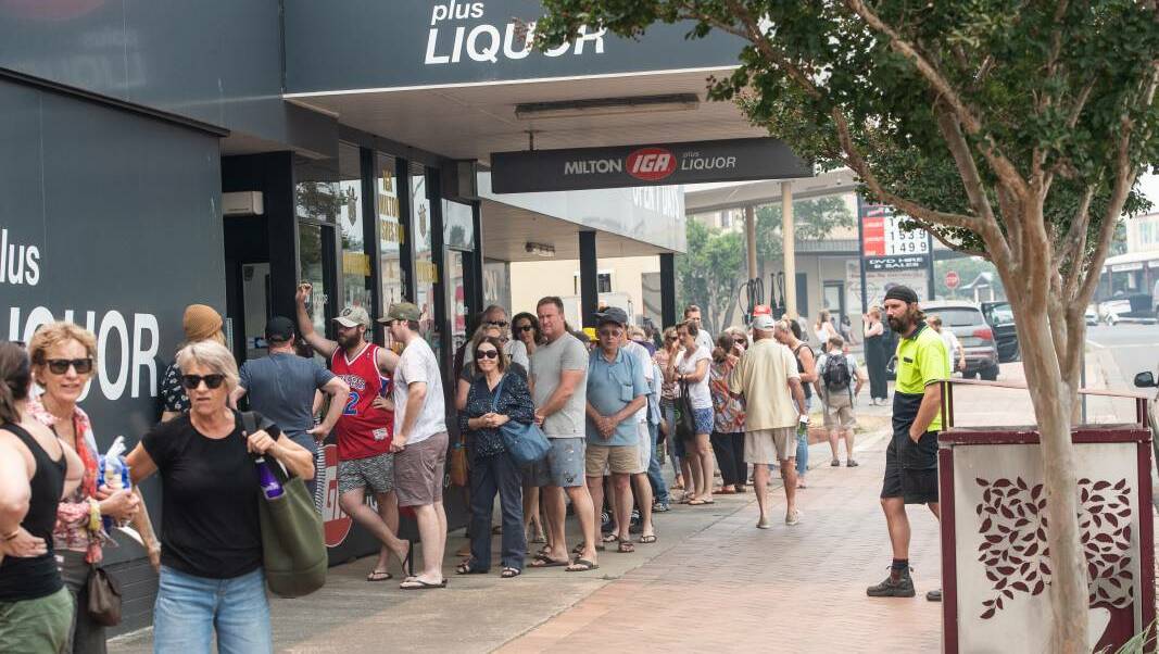 Long queues form at the Milton IGA where shoppers could only purchase six items at once. Picture: Karleen Minney 