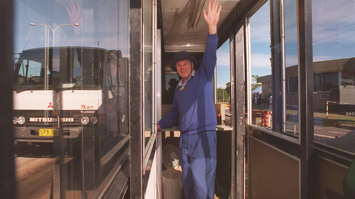 Colin Hagarty, 46, waving goodbye to his friends from his booth at Waterfall. Photo: Greg White