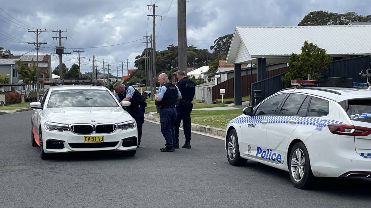 Police near the scene of the crash on Shellharbour Road. Photo: Robert Peet