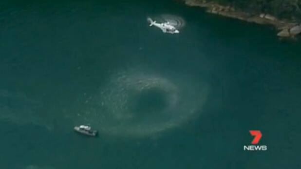 A helicopter hovers over the water near where the seaplane is believed to have gone down.  Photo: Seven News
