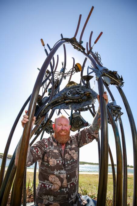 Artist Kane Minogue underneath his new sculpture installed at Shellharbour's Reddall Reserve, as part of its transformation into a regional playground. Picture: Adam McLean.