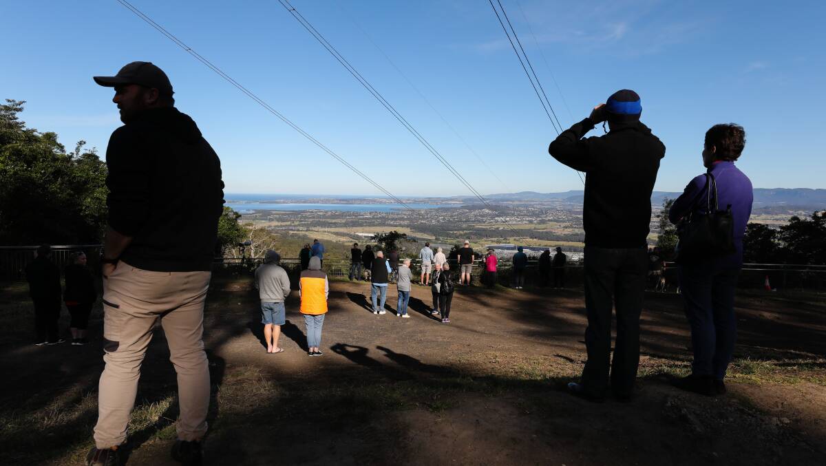 Crowds gather at Mount Keira to farewell the last Qantas Boeing 747-400 in July. 