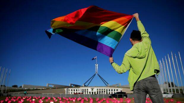 Marriage equality advocate Russell Nankervis with the rainbow flag during a 'Sea of Hearts' event in support of marriage equality at Parliament House earlier this month. Photo: Alex Ellinghausen
