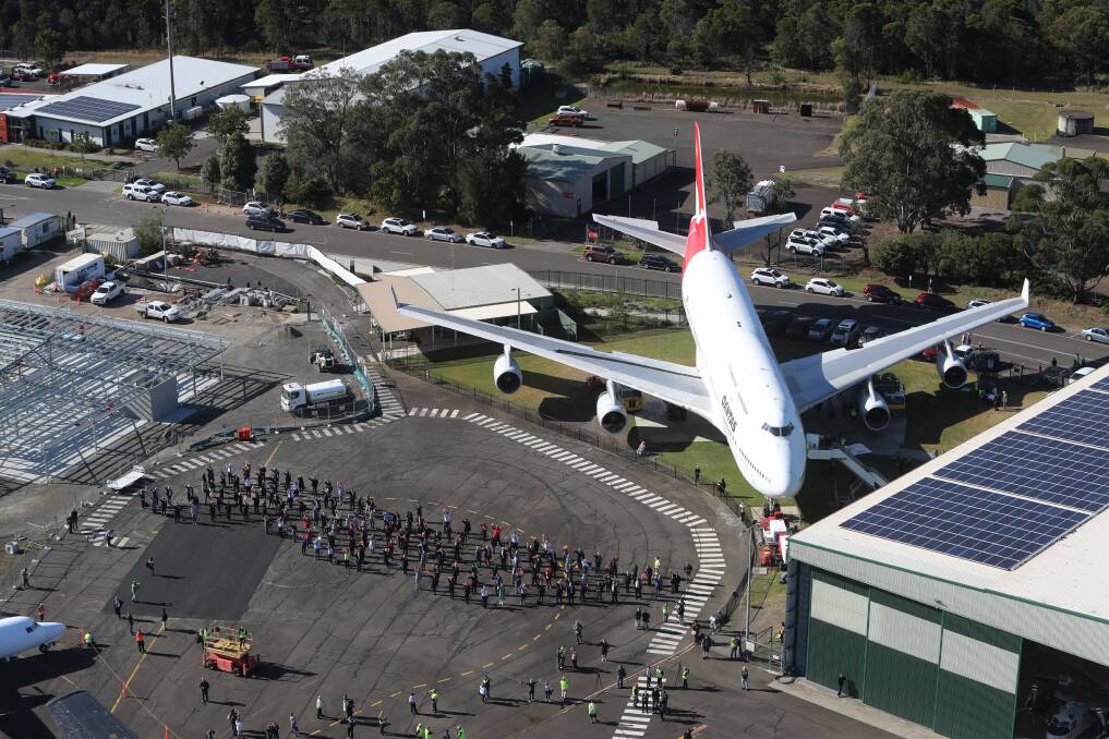 Special tribute: Qantas staff past and present and HARS volunteers spell out a human 747 on the ground. Picture: Robert Peet.
