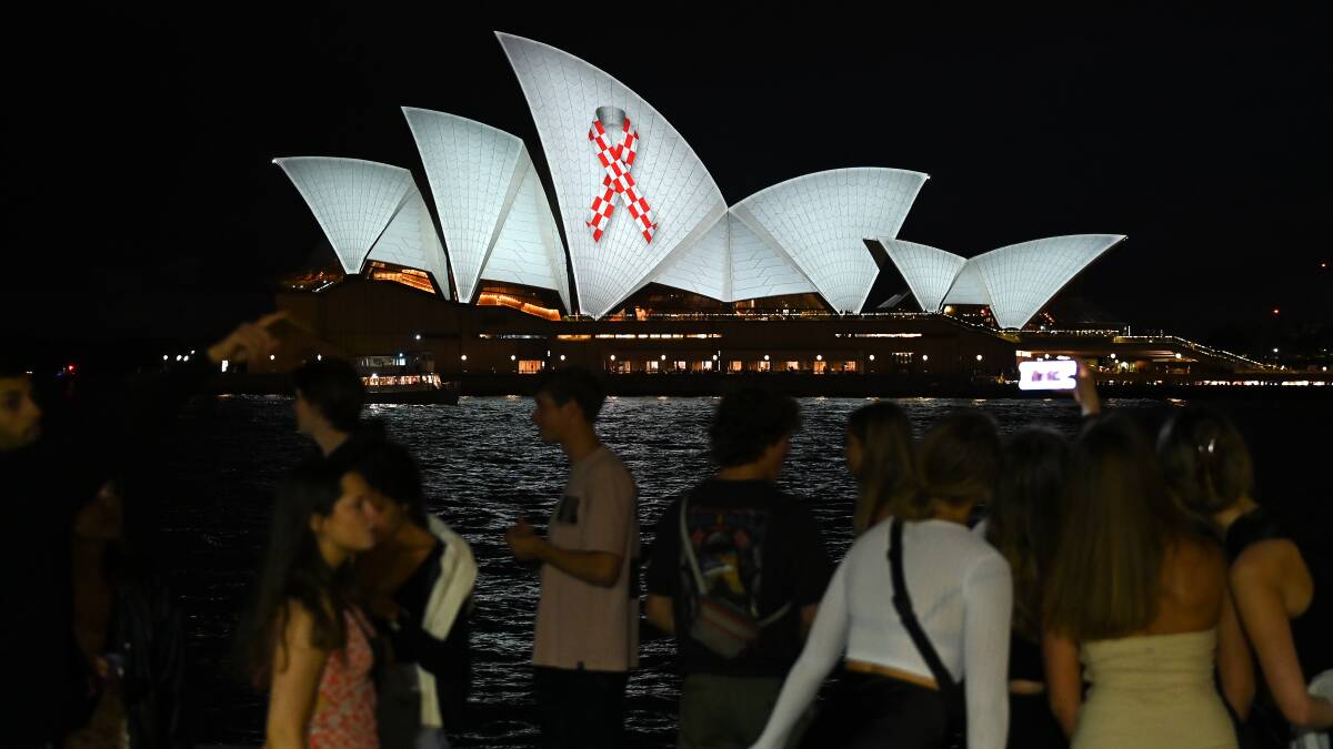 The sails of the Sydney Opera House were lit up on Friday night in tribute to all emergency service workers in the wake of Steven Tougher's tragic death. Picture by AAP