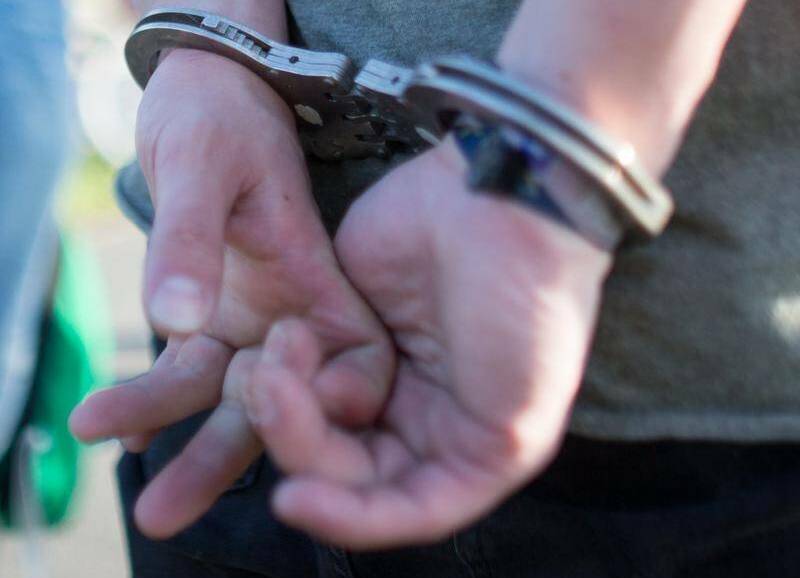 A file image of a man in handcuffs. 