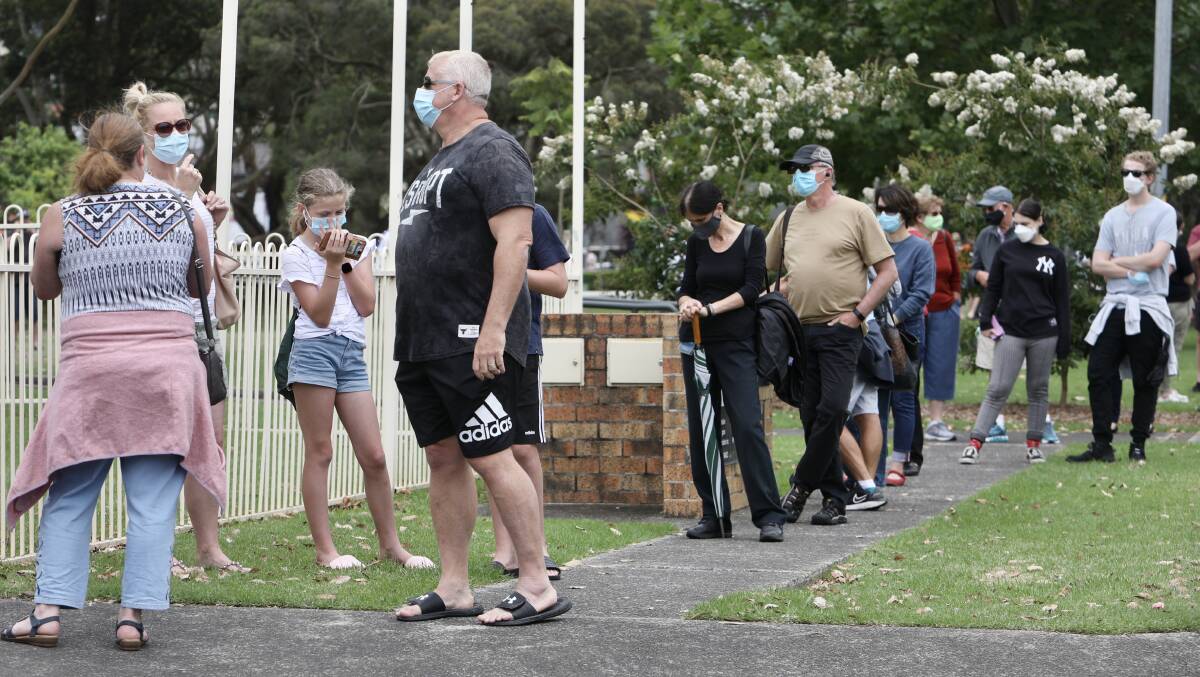 Residents wait in line to get tested for COVID in Figtree on Wednesday. Photo: Adam McLean