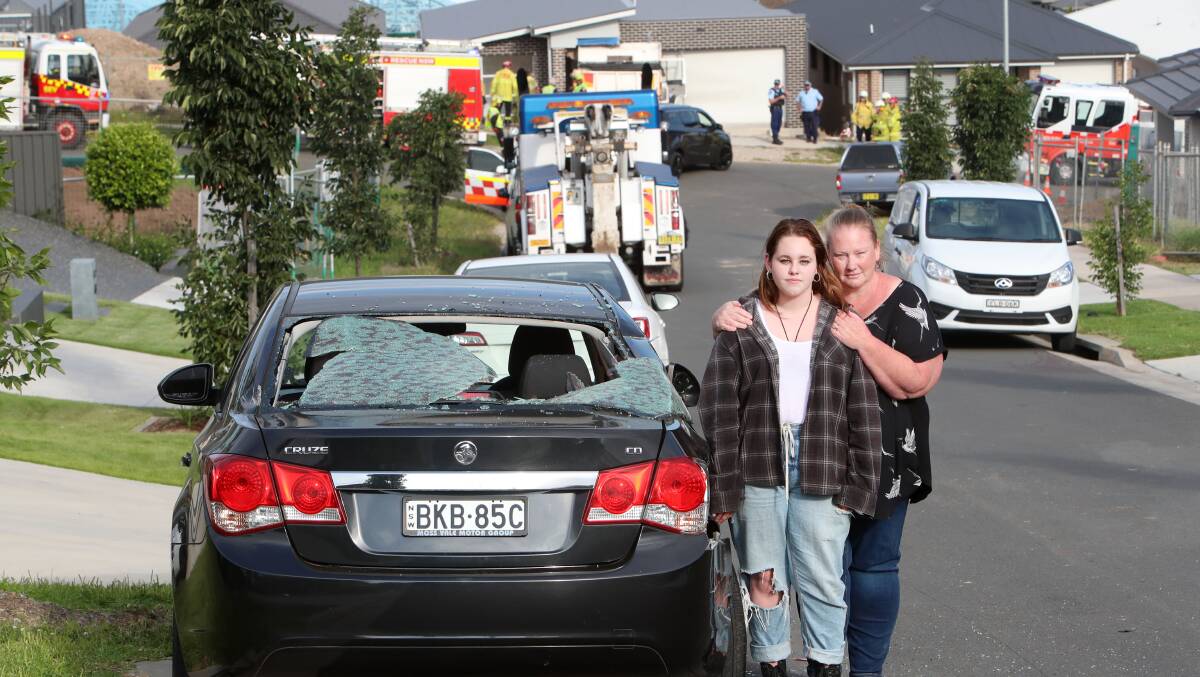 Michelle and Emma Lashbrook next to Ms Lashbrook's new car that was the first of the two family vehicles hit by a runaway truck on Friday afternoon. Picture: Sylvia Liber.