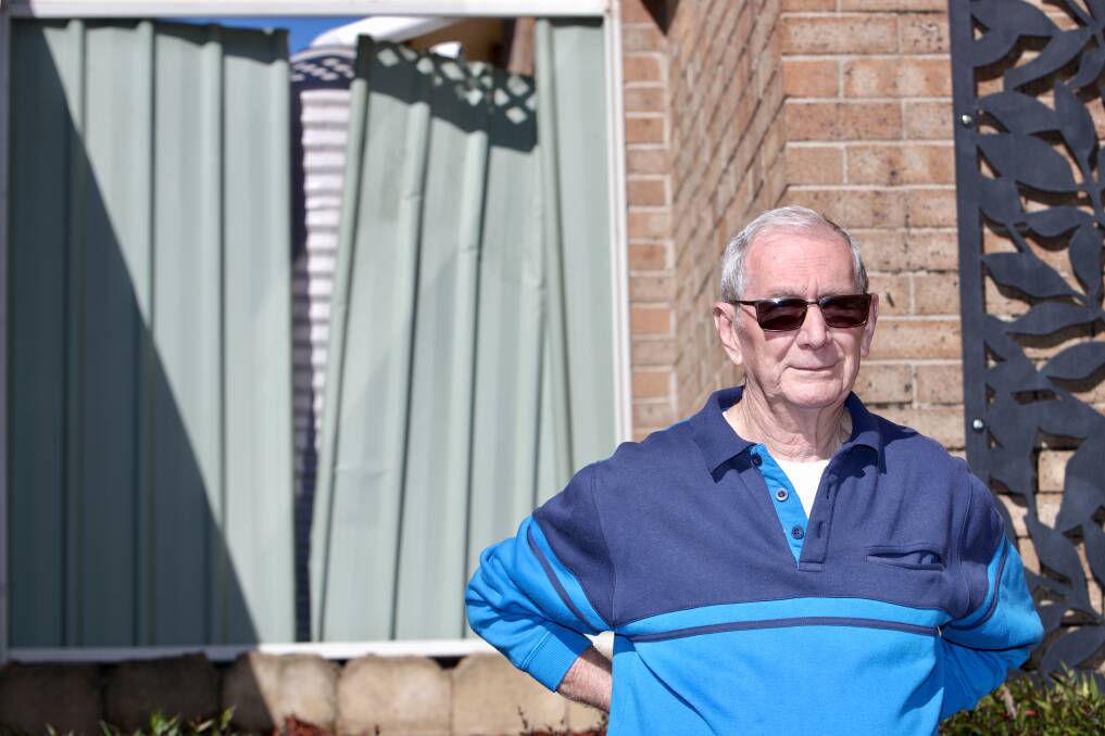 Govett Crescent resident Wal Burkinshaw in front of his damaged fence. Photo: Adam McLean