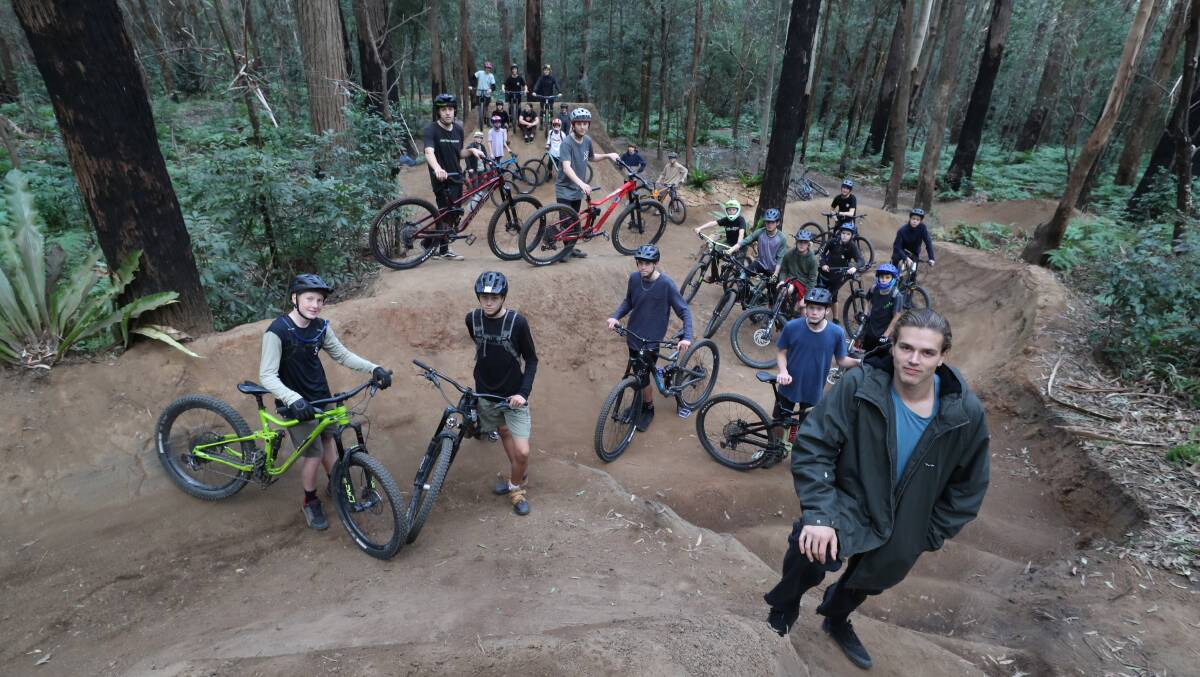 Wayne Clarke with riders at Possums mountain bike trail. Photo: Robert Peet