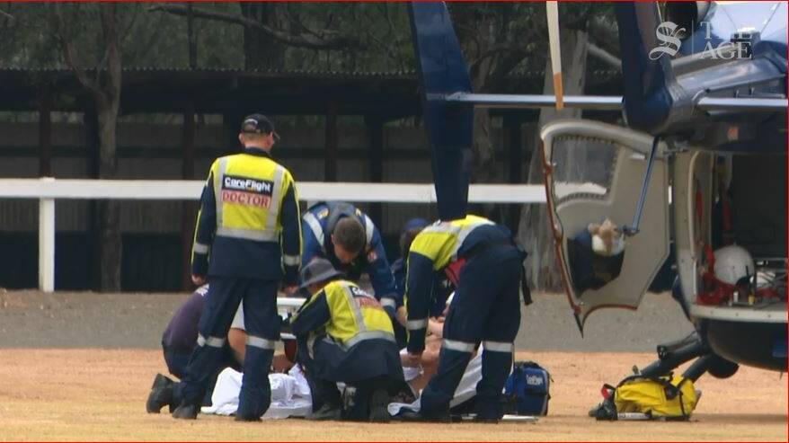 Ambulance officers attend to a firefighter who was injured at Bargo and had to be airlifted to hospital. Picture: Nine News 