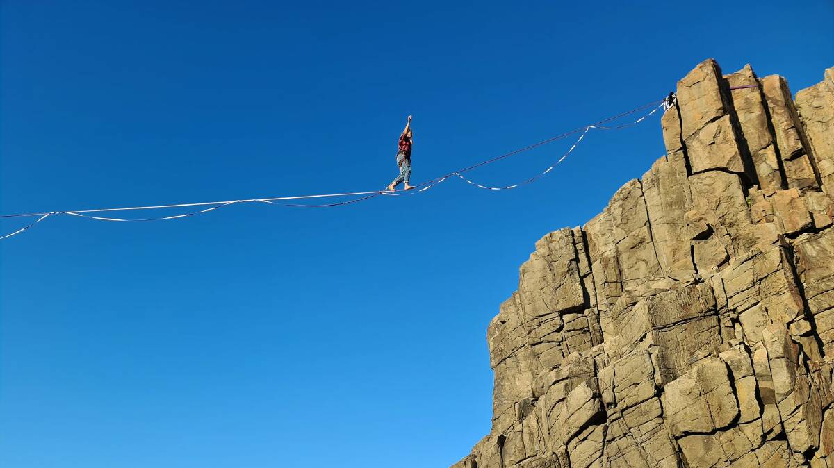 A tightrope walker crosses between two rock platforms at Bombo Quarry. Photos: Rowan Hollingworth 
