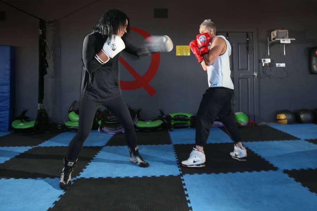 Cyd Mardon and Kerrie Lawrence working sparring drills. The pair will walk the entire 24 hours for the Relay For Life. Photo: Adam McLean