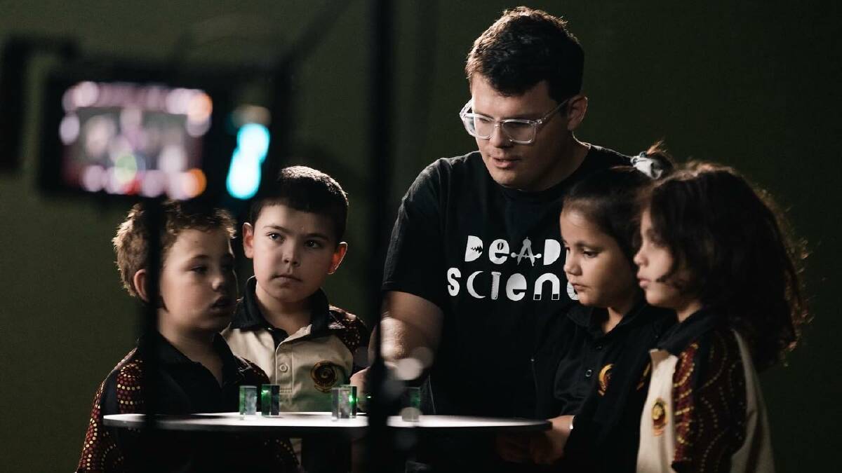 Corey Tutt with budding young scientists. Photo: Supplied by McLaren and Smartsheet