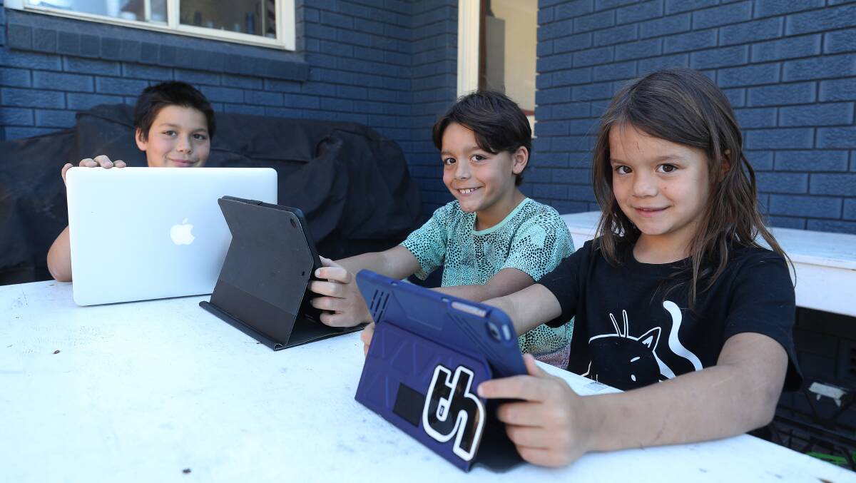 Mount Ousley Public School students Hirada, Steo and Koha Lawler have the skills they need to make the most of remote learning. Photos: Robert Peet.