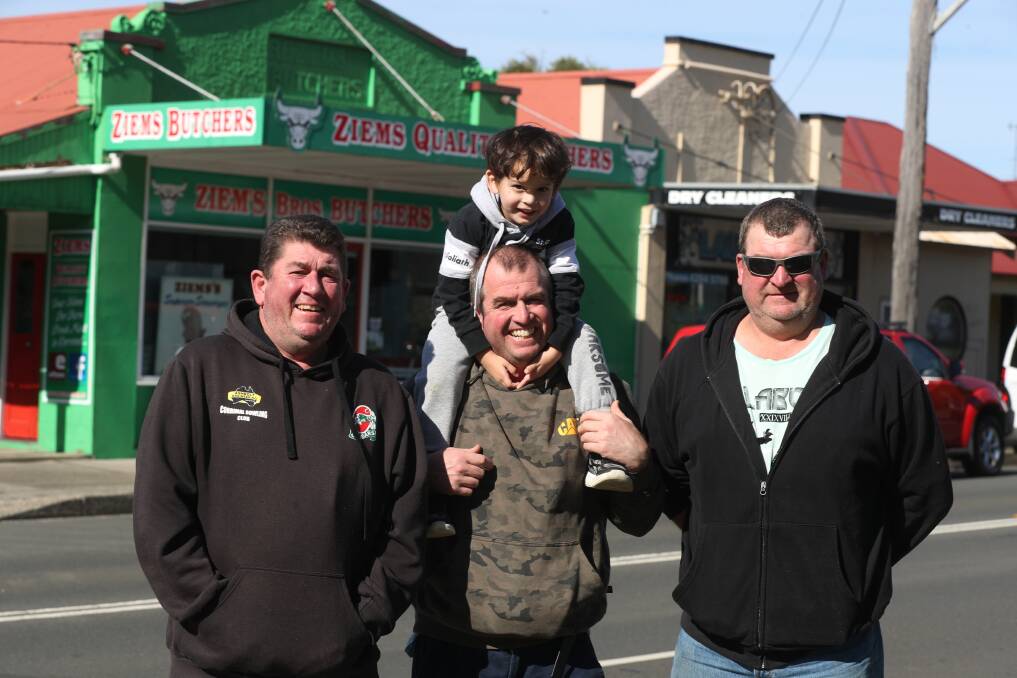 FAMILY BUSINESS: Matt Ziems, Robert Ziems with Robert junior and Danny Ziems outside the Corrimal butcher shop. Picture: Robert Peet
