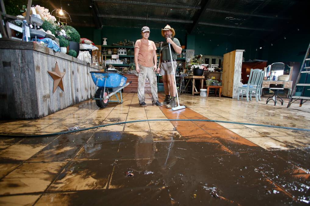 SMASHED: Rick and Sharni Smith, owners of Havenwood Tiny Homes in Albion Park Rail, were hard at work cleaning up after floods on Thursday. Picture: Anna Warr