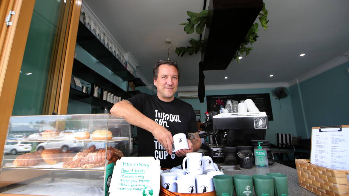 Blackbird cafe owner Chris Henry with their mug library - part of a new push against single-use cups. Picture: Sylvia Liber.