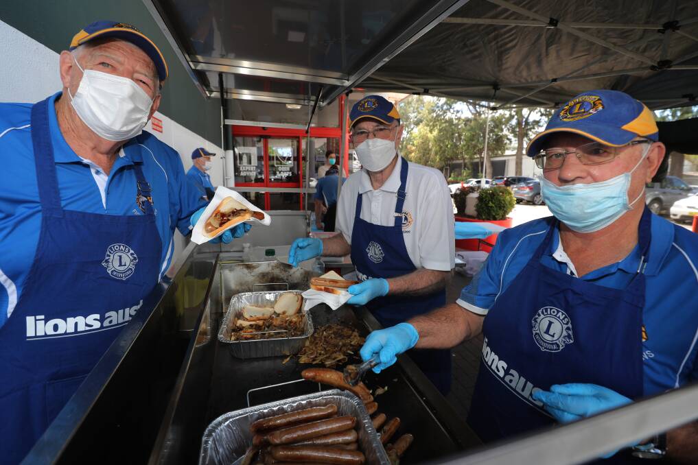 IT'S BACK: Figtree Lions Club members Kevin Hartley, Rob Sassall and Dave Berry manning the Wollongong Bunnings sausage sizzle on Saturday. Picture: Robert Peet.