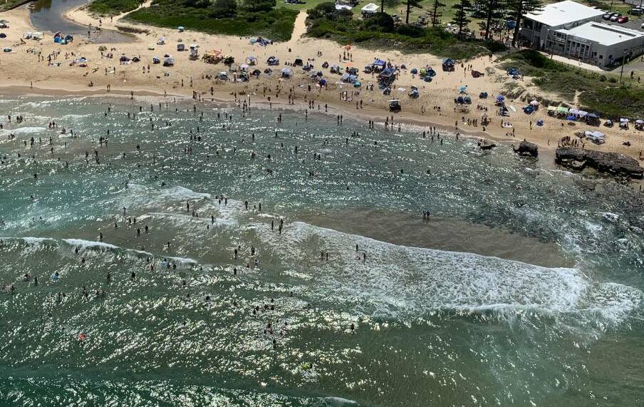 PACKED: An aerial shot of Bulli Beach on the morning of Australia Day. The beach was later closed due to a shark sighting. Picture: Westpac Life Saver Rescue Helicopter