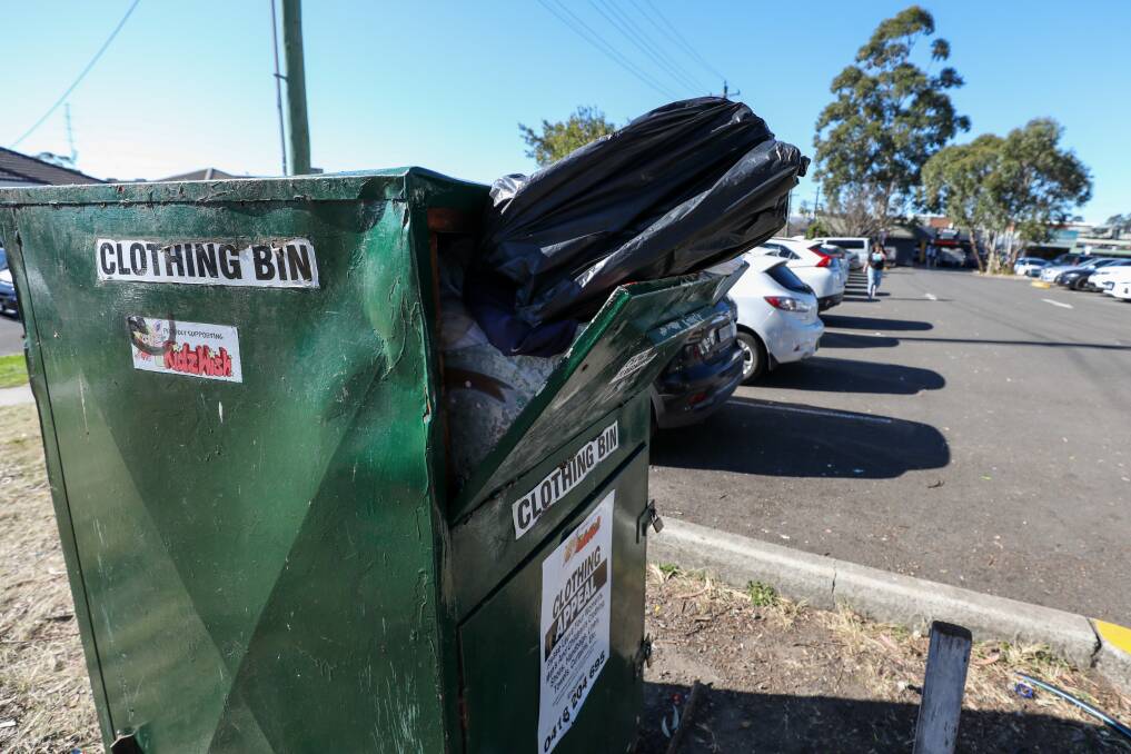 An over-flowing charity clothing donation bin in the Woolworths car park in Unanderra on August 6. Picture: Adam McLean.