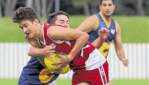 Illawarra Lions' Jack Thompson looks to break a tackle against Holroyd- Parramatta. The Lions are back at North Dalton Park to take on Macquarie University on Saturday. Picture: ROBERT PEET