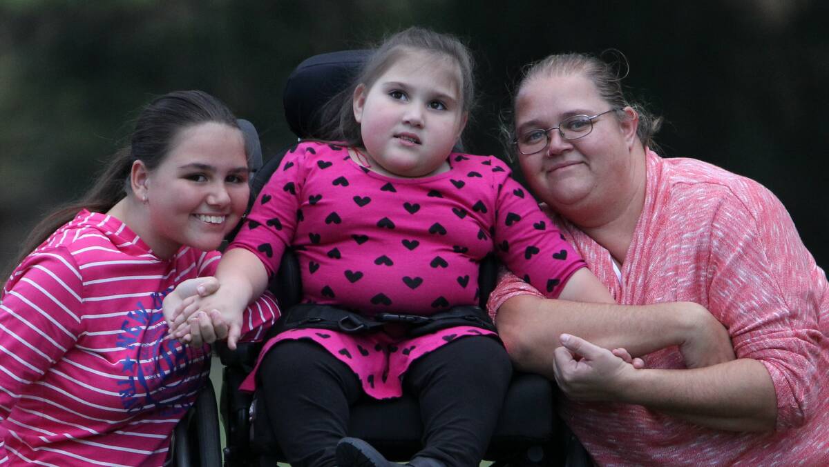 Sylvia Connolly, right, with Syesha who suffers from spina bifida and paralysis, and older daughter Teearnna. Picture: GREG TOTMAN