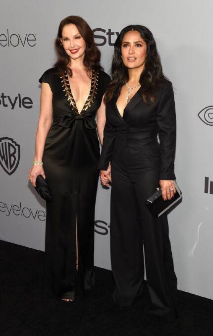 Ashley Judd, left, and Salma Hayek arrive at the InStyle and Warner Bros. Golden Globes afterparty at the Beverly Hilton Hotel on Sunday, Jan. 7, 2018, in Beverly Hills, Calif. (Photo by Chris Pizzello/Invision/AP)