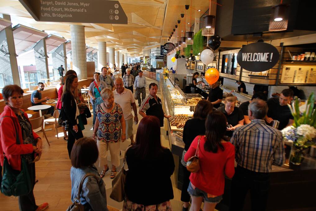 A crowd of people line up for coffee in the food court at the opening of Wollongong Central. Picture: CHRISTOPHER CHAN
