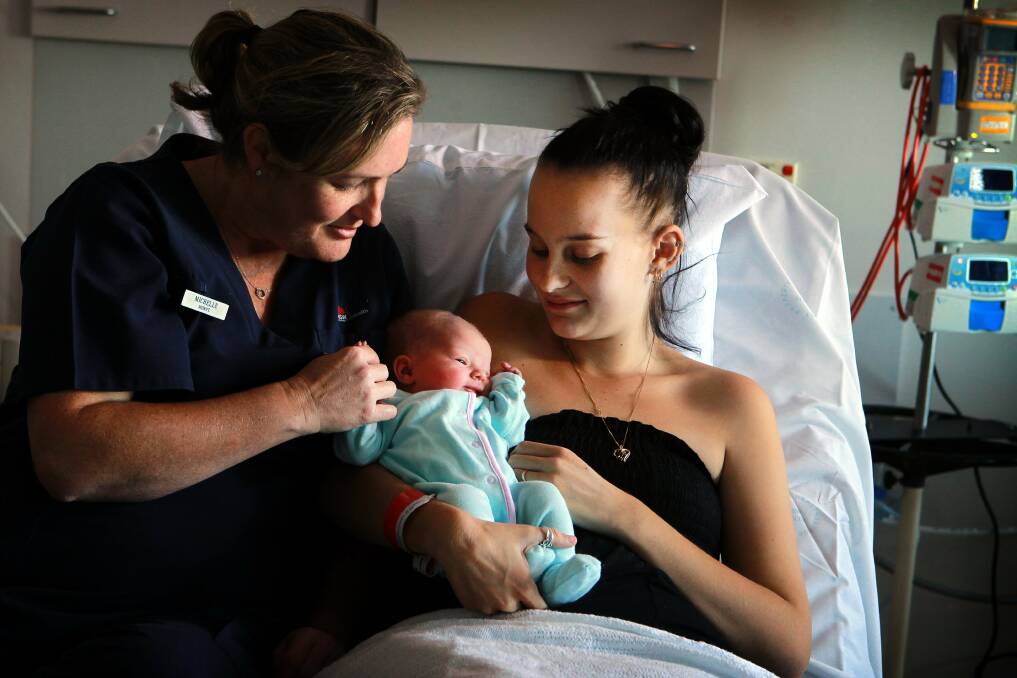 Delivery: Midwife Michelle Smid delivers newborn Bella Lee to the loving arms of her mother Tenneile Meyers. Picture: SYLVIA LIBER