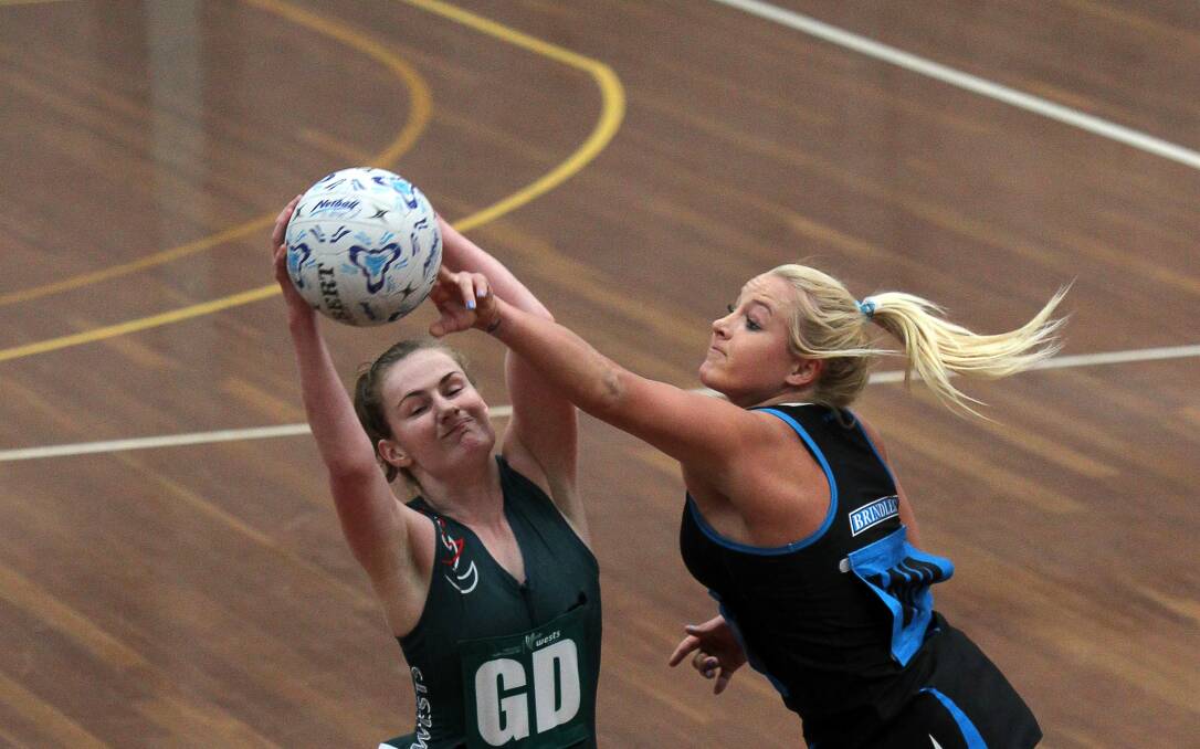 Titans goal defence Emily Osborne (left) wins a tough possession in the preliminary final victory over Brindles. Picture: SYLVIA LIBER