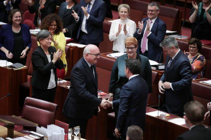 Leader of the Opposition in the Senate Penny Wong, Attorney-General George Brandis and Senator Dean Smith celebrate as the Marriage Amendment Bill goes through the Senate, at Parliament House in Canberra on  Wednesday 29 November 2017. fedpol Photo: Alex Ellinghausen