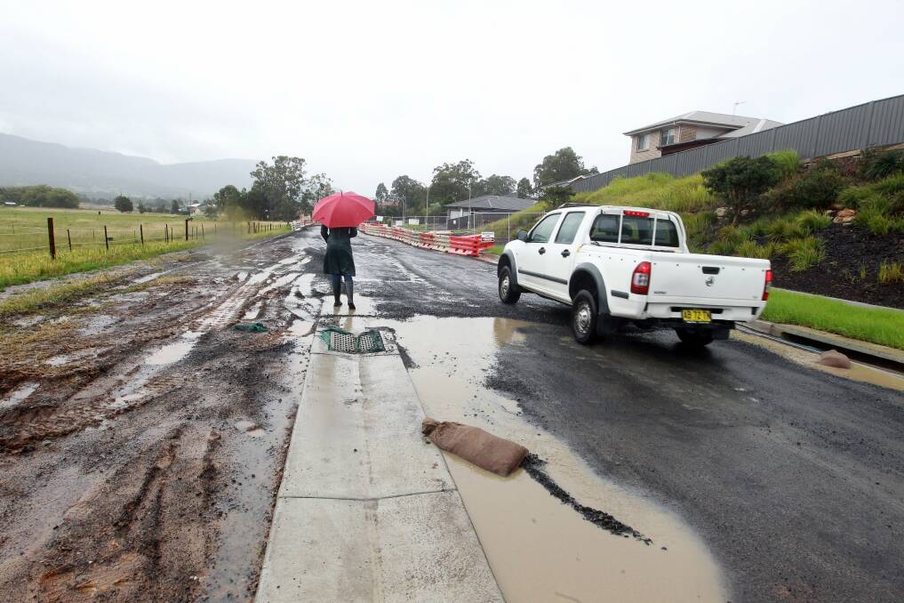 Substandard: The Illawarra Mercury surveyed Bong Bong Road after workers filled in some of the potholes with gravel.Picture: SYLVIA LIBER