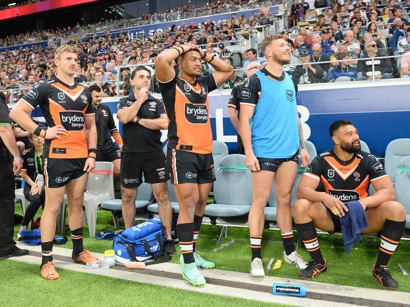 Tigers players watch in dismay as Valentine Holmes takes the match-winning penalty in Townsville. (Scott Radford-Chisholm/AAP PHOTOS)