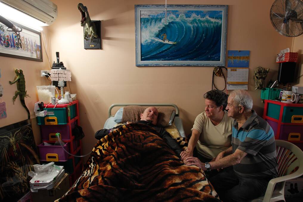 Richard Kramer, who will lose four hours of care a week, with his parents, Heather and Brian Langlands. Picture: CHRISTOPHER CHAN