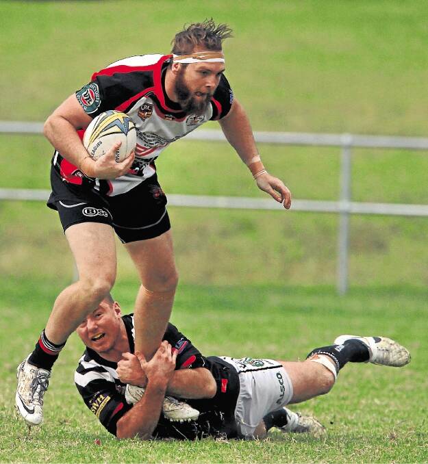 First grade: Kiama's Jacob Dolan is tackled by a Port Kembla defender on Sunday.Picture: SYLVIA LIBER