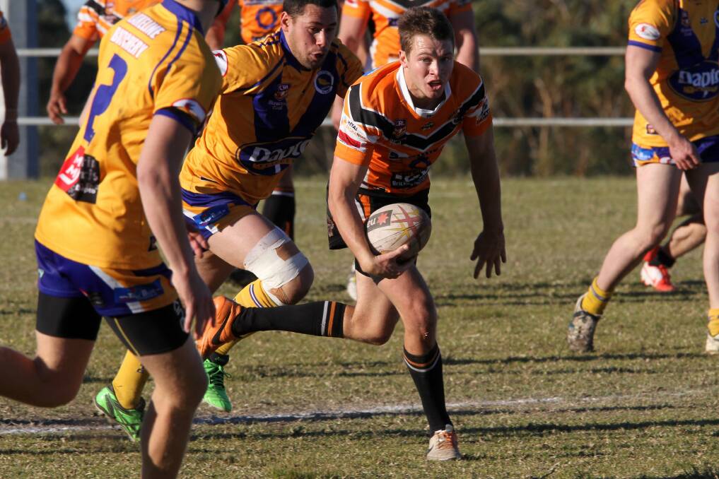 Helensburgh's Eamon Hillen makes a break against Dapto. The Tigers handed the Canaries a hefty 56-12 defeat. Picture: GREG TOTMAN