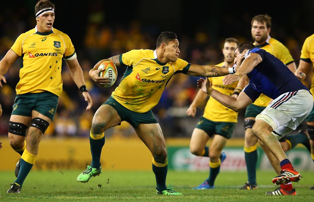 Israel Folau fends a French rival in the tough second Test at Etihad Stadium. Picture: GETTY IMAGES