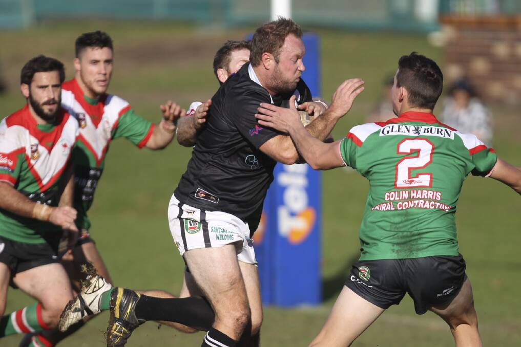Port Kembla centre Richard Pollard tries to squeeze through a gap in the Jamberoo defence during his side's big loss at Kevin Walsh Oval on Sunday. Picture: Picture: DAVID HALL