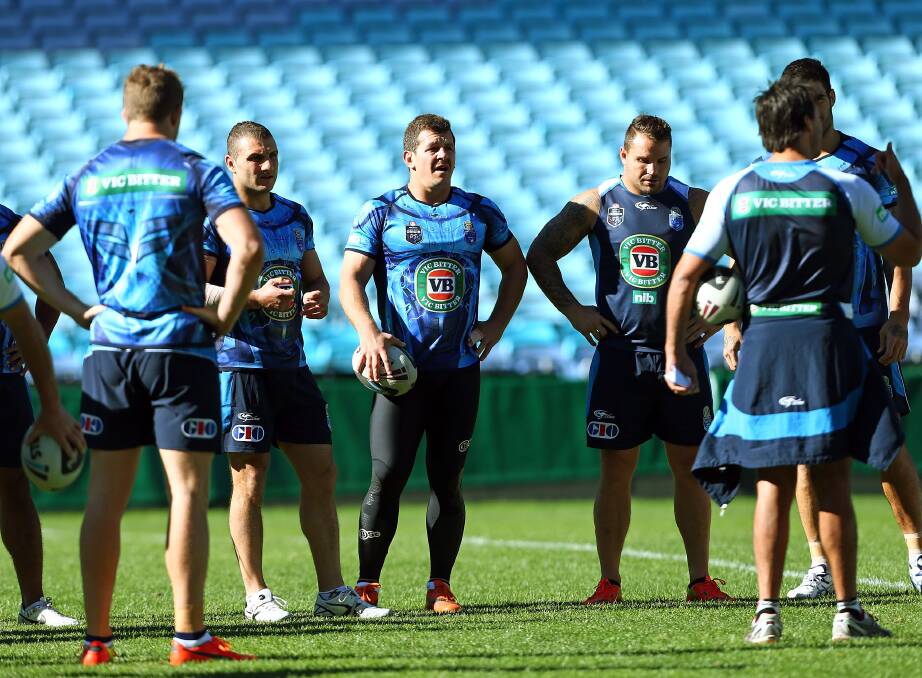 Blues players Robbie Farah, Greg Bird and Anthony Watmough listen to instructions at Origin training. Picture: GETTY IMAGES