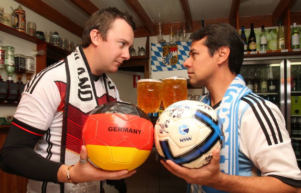 German Club’s Andrew Gunn, left, and 
Argentinian fan Javier Ayala share a beer in a friendly face-off.  Picture: GREG TOTMAN