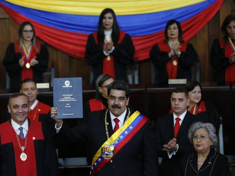 Venezuelan President Nicolas Maduro (C) has been sworn in, despite calls for him to step down.